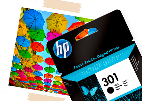 A HP 301 Ink Cartridge, next to a printed photo of multicolour umbrellas