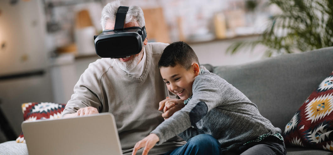 grandpa and grandson playing vr on a laptop
